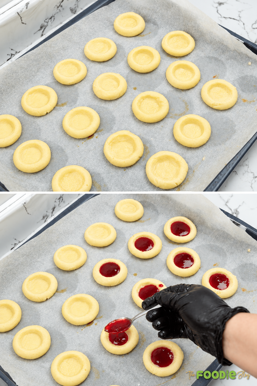 Shortbread cookies on a baking sheet being filled with strawberry jam before baking.